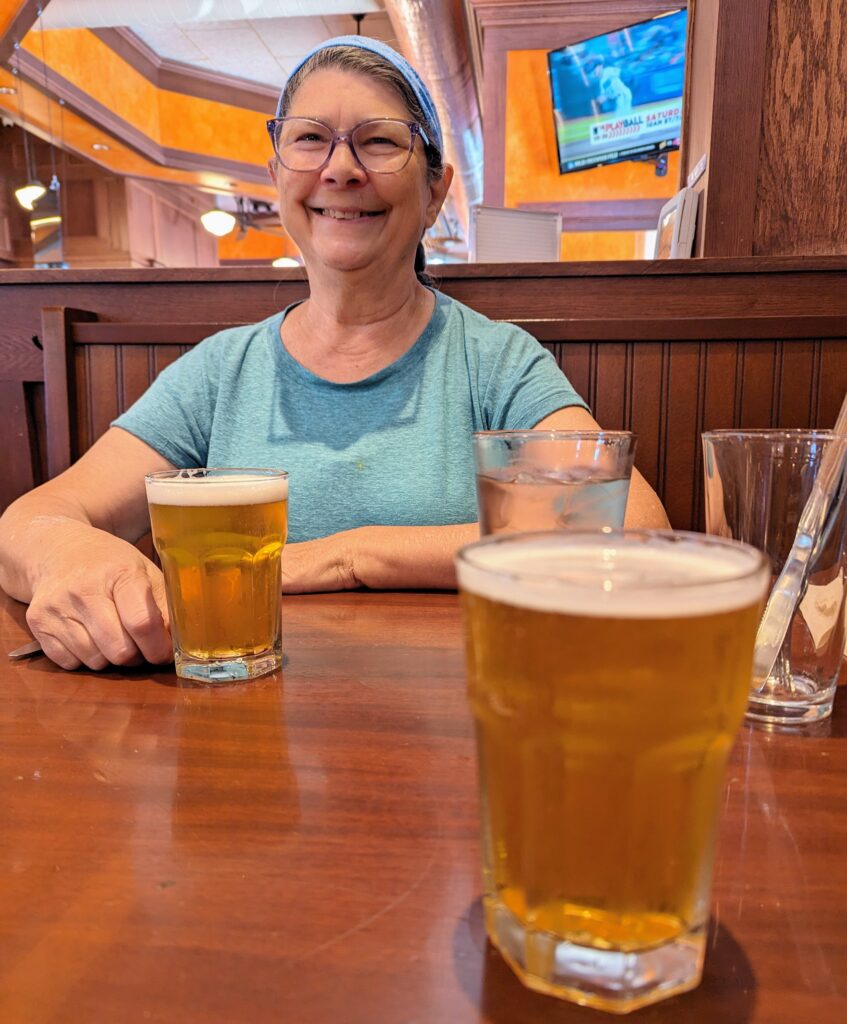 A picture of Jackie with her and my beer in front of her