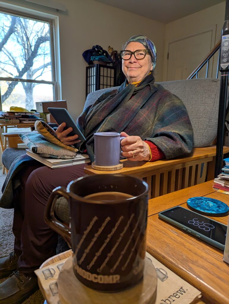 My mug of hot cocoa in the foreground, and Jackie with her mug of hot cocoa sitting beyond it