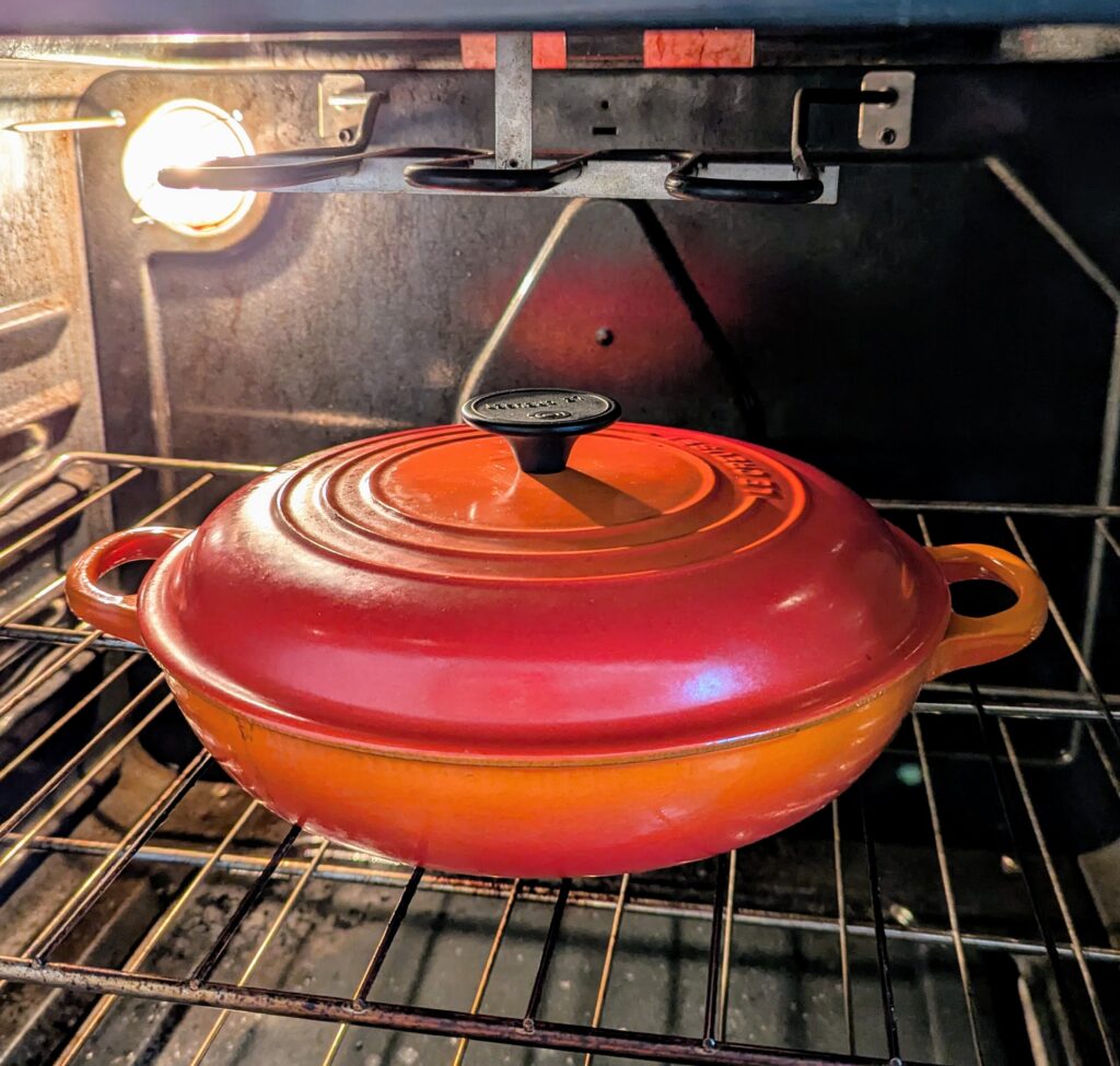 Orange braising pan in the oven